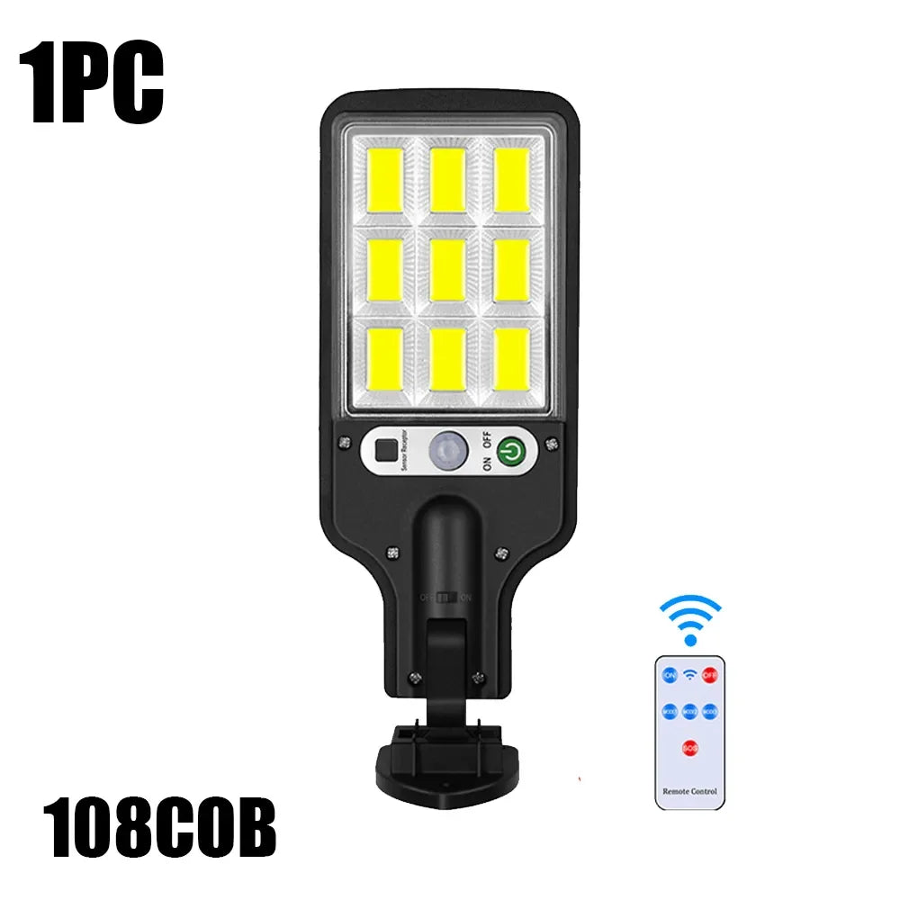 A black solar powered motion sensor security light with 108 LED bulbs and a remote control.