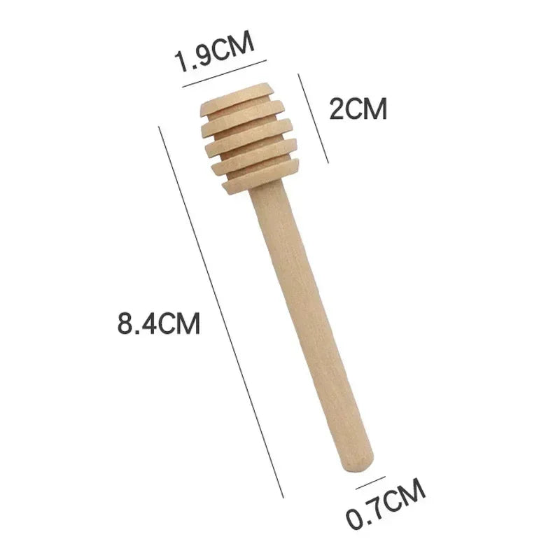 A wooden honey dipper stick with measurements indicating its size.