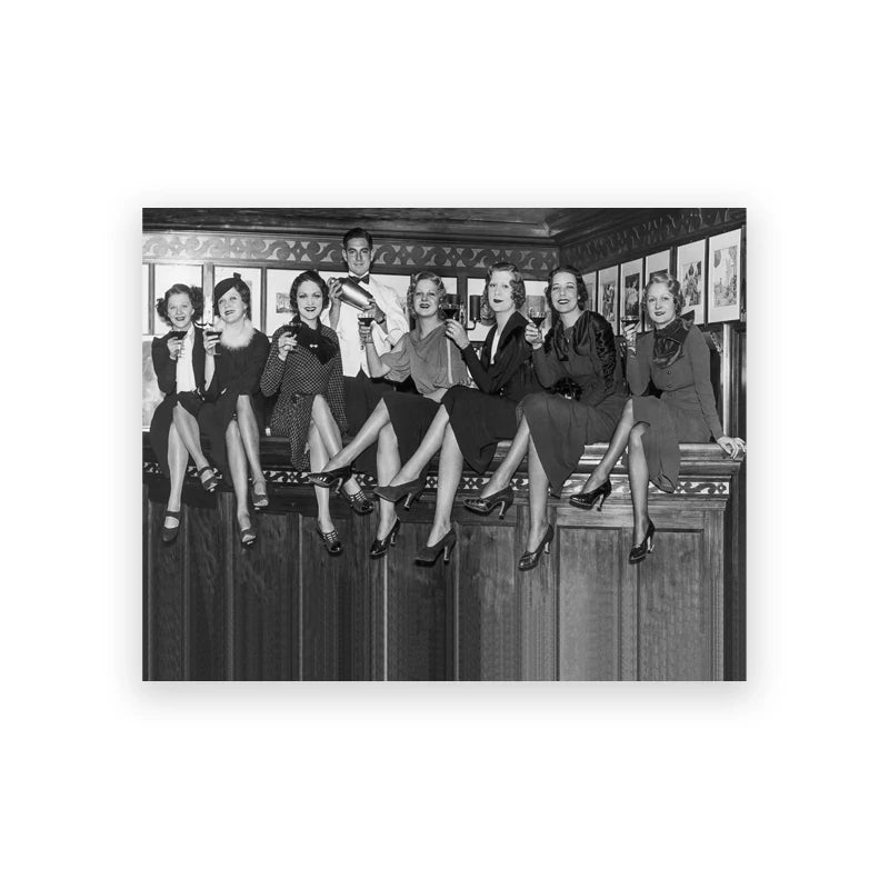 Black and white photograph of a group of women posing in a vintage style, likely from the Prohibition era.