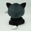 A dark gray plush toy resembling a cat's back with pointed ears and a white muzzle.