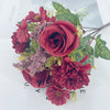 A bouquet of artificial red and pink roses, daisies, and chrysanthemums arranged on a white background.