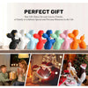 A collection of colorful Nordic balloon dog resin sculptures in various colors displayed on a wooden surface.