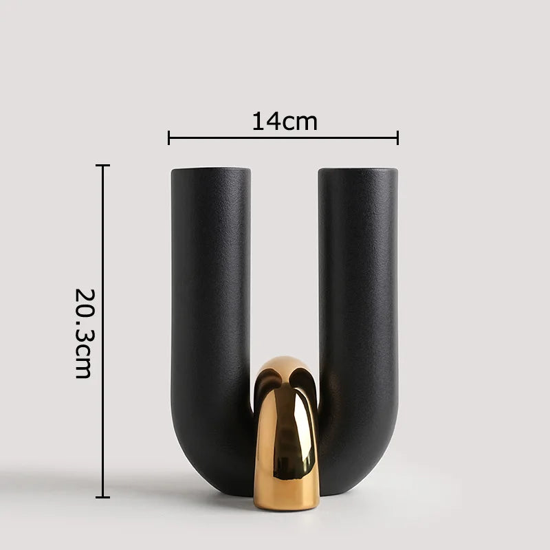 A black ceramic U-shaped tabletop vase with a gold accent, shown in a vertical view.