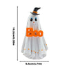 A white ghost figurine with a pointed hat and glowing eyes for Halloween decor
