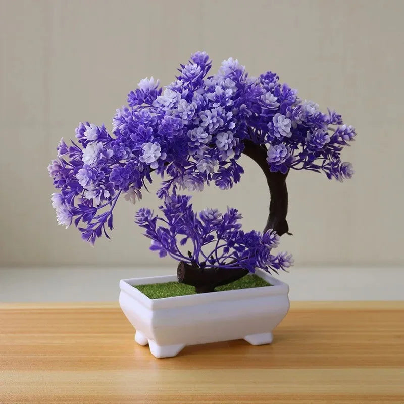 Artificial bonsai tree decoration with purple and white blossoms in a white planter