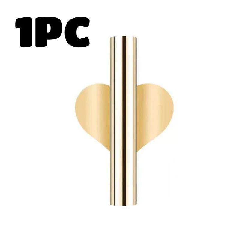 One piece of a modern wall-mounted flower vase with an elegant gold and black finish.