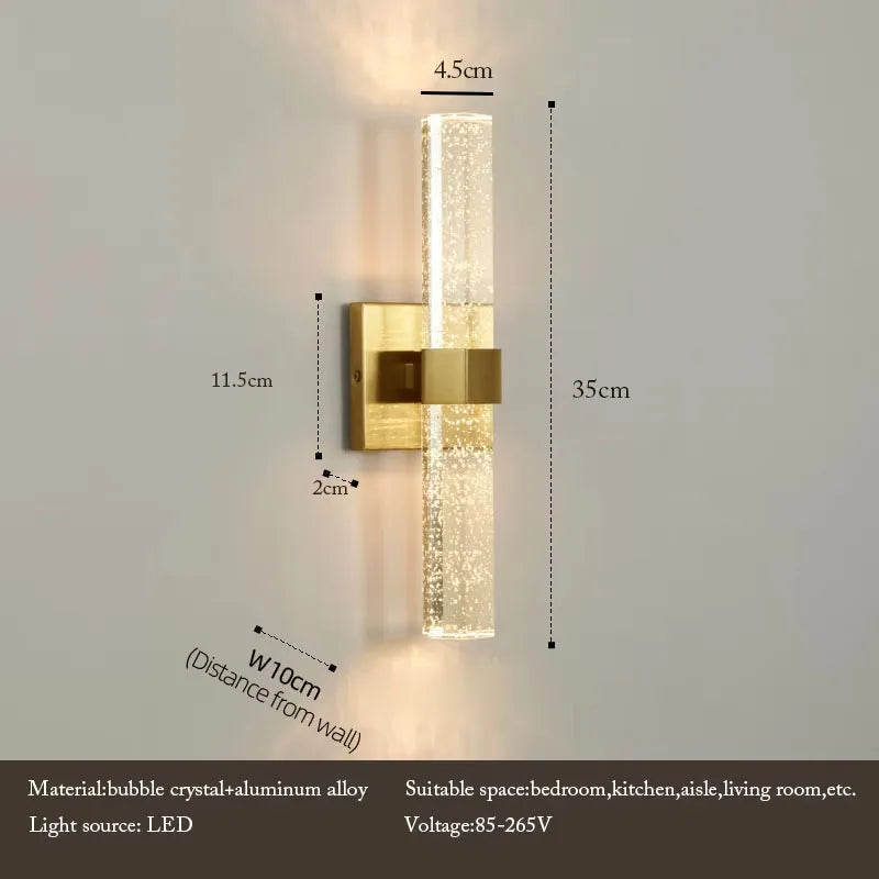 Modern bubble crystal and aluminum alloy LED wall sconce with a brass finish mounted on a wall.