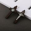 A set of wooden crucifix pendants featuring embossed religious imagery on a dark background.