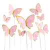 Pink paper butterfly cake toppers on thin sticks