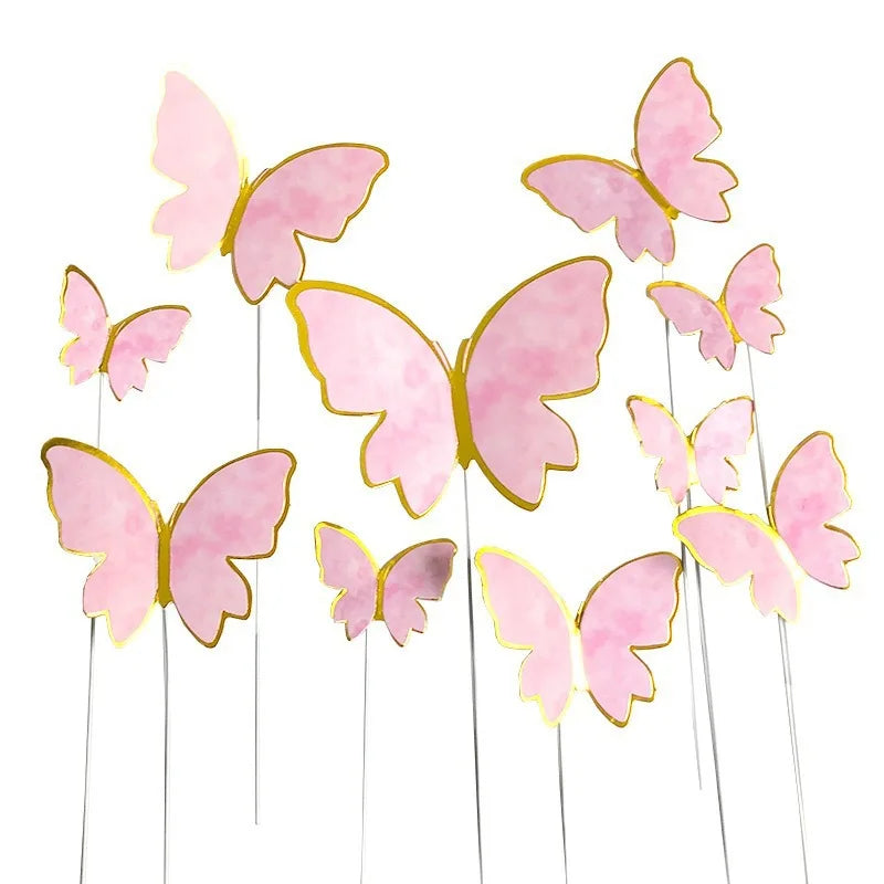 Pink paper butterfly cake toppers on thin sticks