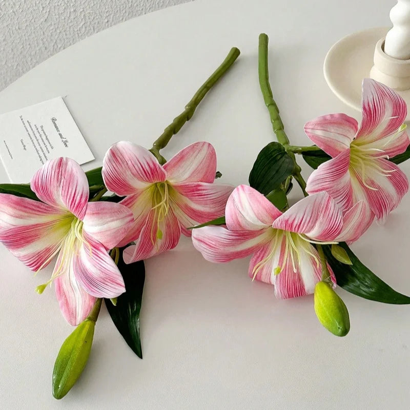 Three stems of pink and white artificial lilies with buds for home and event decor
