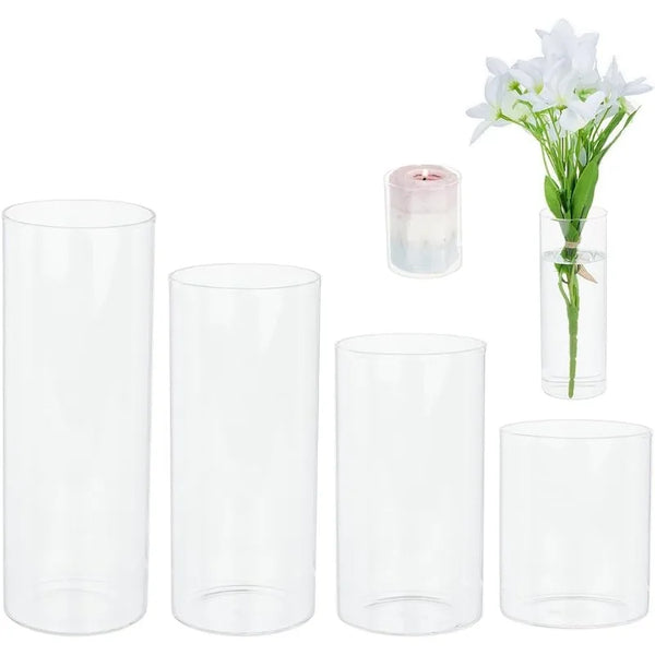 A set of four clear glass cylinder vases for candles and floral displays.