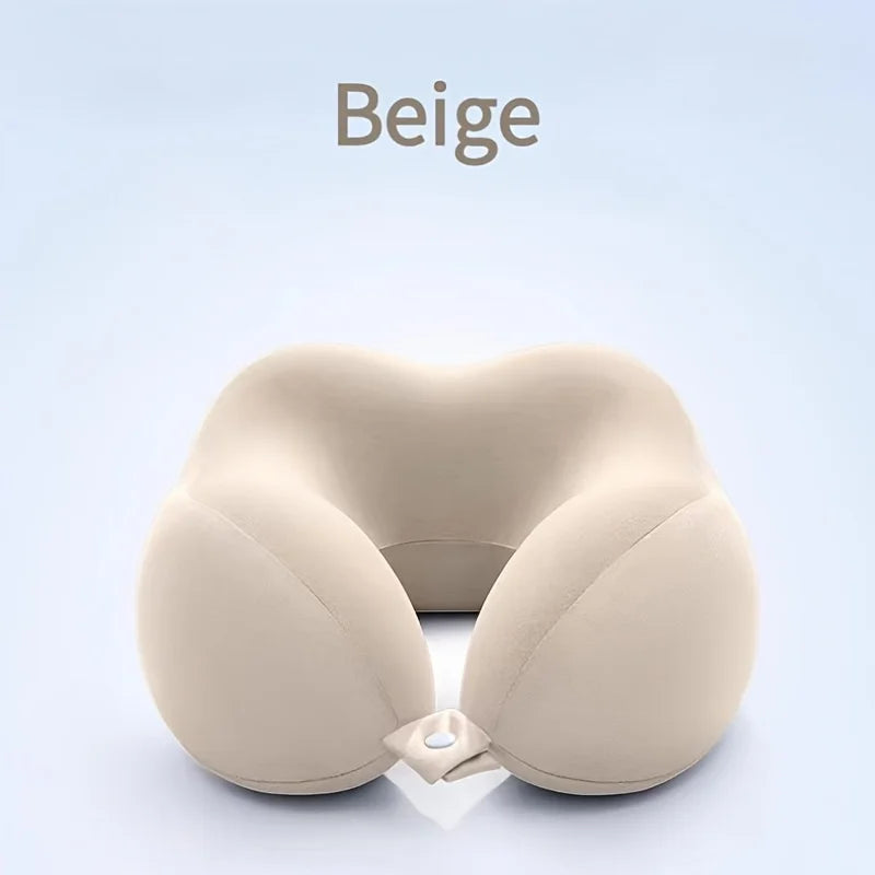A beige U-shaped memory foam neck pillow shown against a light blue background.