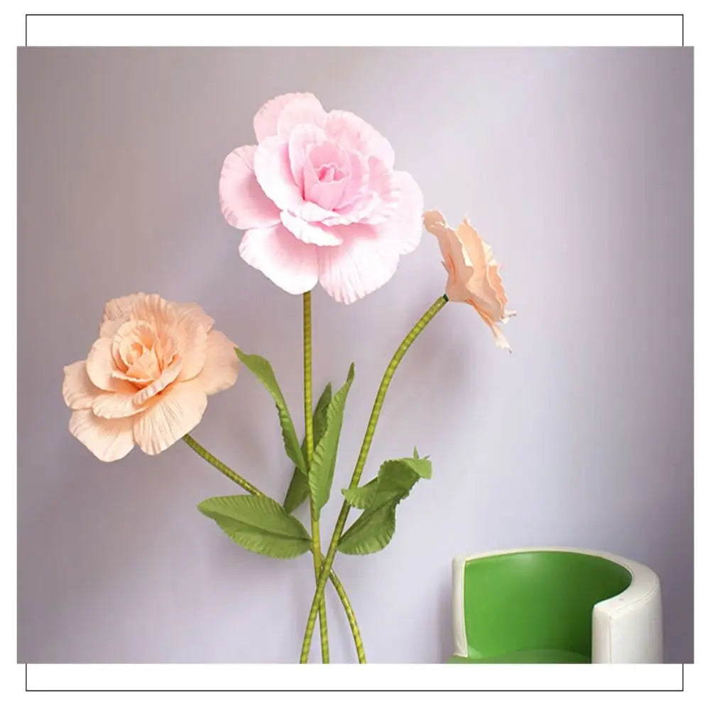 A cluster of lifelike silk foam roses in shades of pink and peach on a green stem.