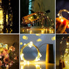 A collection of LED wine bottle cork lights illuminating various bottles and creating decorative light effects.