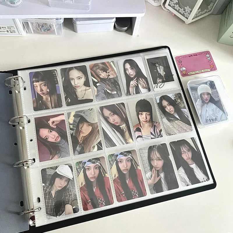 A black grid binder filled with various photocards featuring female idols and other subjects.