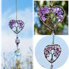 A hanging crystal tree of life sun catcher made of purple amethyst crystals and gold wire.