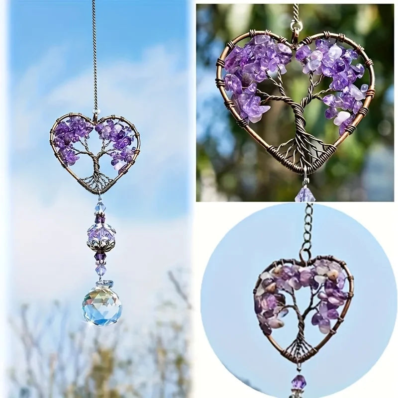 A hanging crystal tree of life sun catcher made of purple amethyst crystals and gold wire.