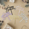 A collection of elegant acrylic birthday cake toppers with various script fonts and gold lettering on a beige background.