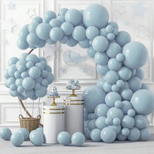 A large archway made of light blue latex balloons decorated with white stars and clouds.