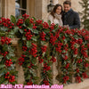 Artificial red berry holly Christmas garland draped over a stone ledge with a couple in the background