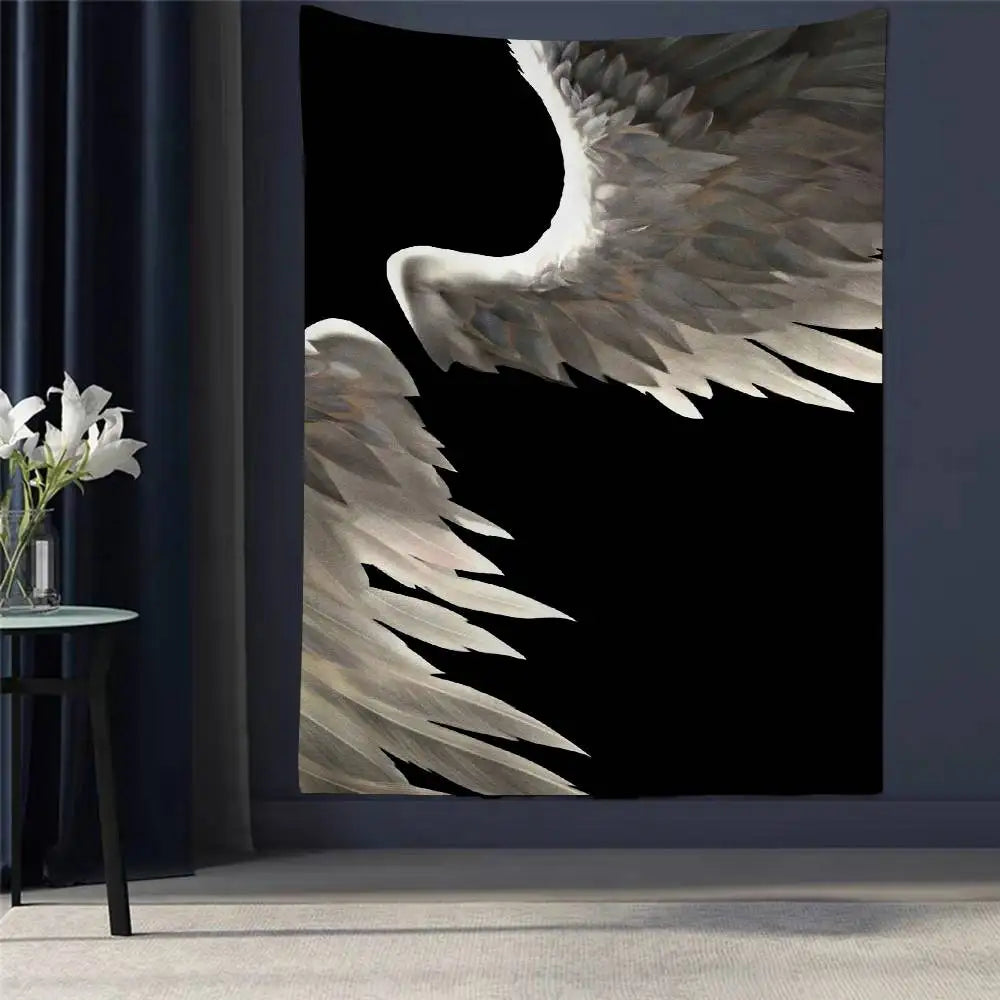 A tapestry wall hanging featuring a close-up of large, feathered angel wings in shades of gray and white against a black back