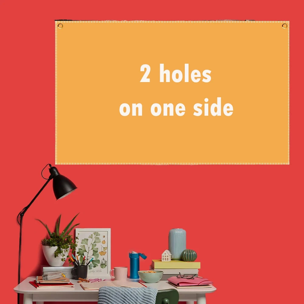 A bright orange rectangular sign with the text 2 holes on one side displayed on a red wall.