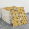 A stack of marble peel-and-stick tiles with gold accents displayed next to a single tile.