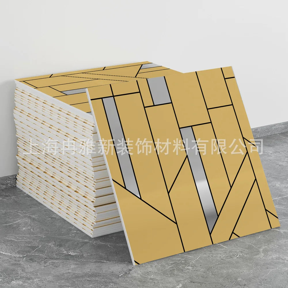 A stack of marble peel-and-stick tiles with gold accents displayed next to a single tile.