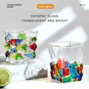 Faceted crystal whiskey glass with colorful facets displayed on a white box.