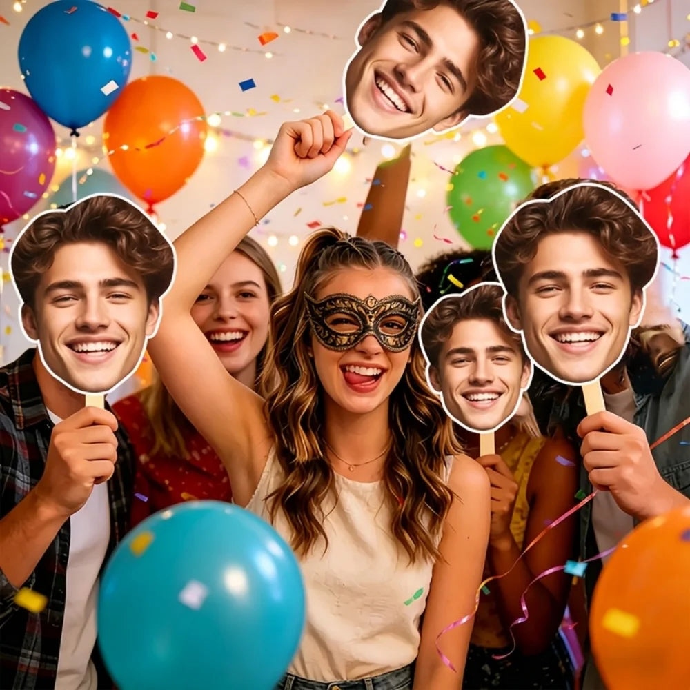 Group of young adults smiling and holding custom face photo props on sticks in a party setting