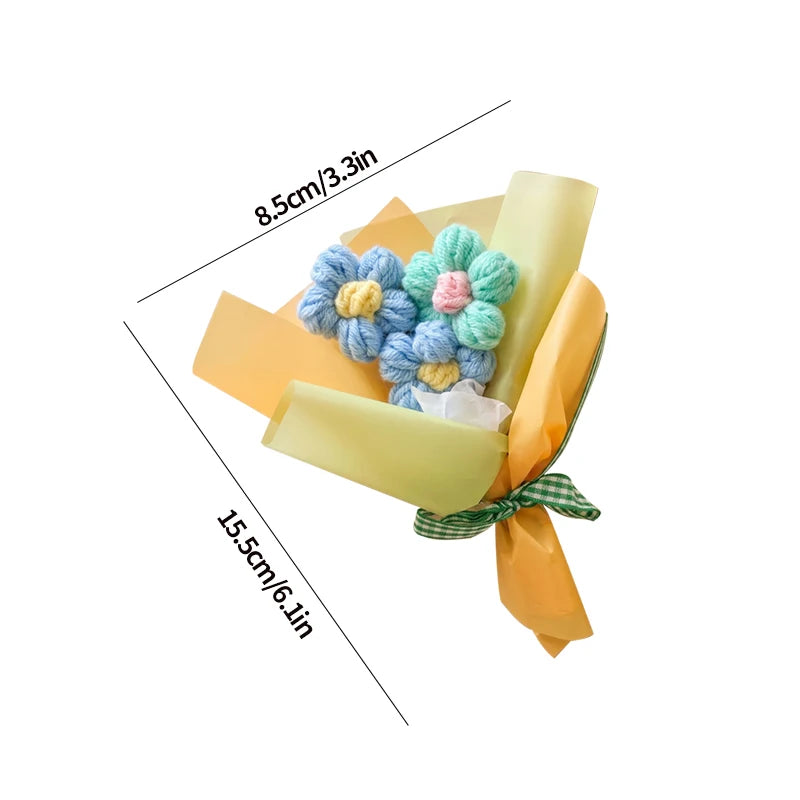 A handmade crochet sunflower mini bouquet wrapped in yellow paper and tied with a green ribbon.