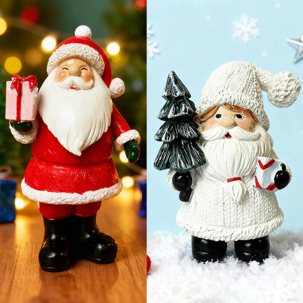 A pair of resin Santa Claus ornaments, one in red and white, and one in white, standing on a snowy surface.
