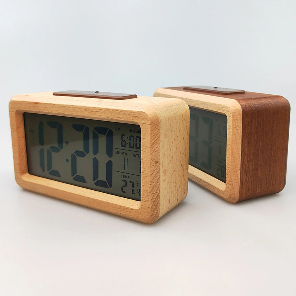 A light wood digital alarm clock with a display showing time, date, and temperature.