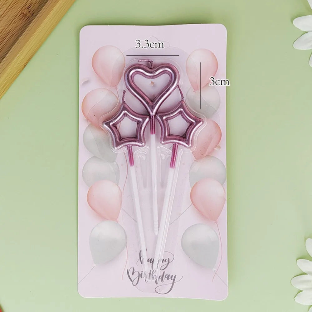 A set of pink and white balloons with heart and star shapes arranged on a rectangular card.