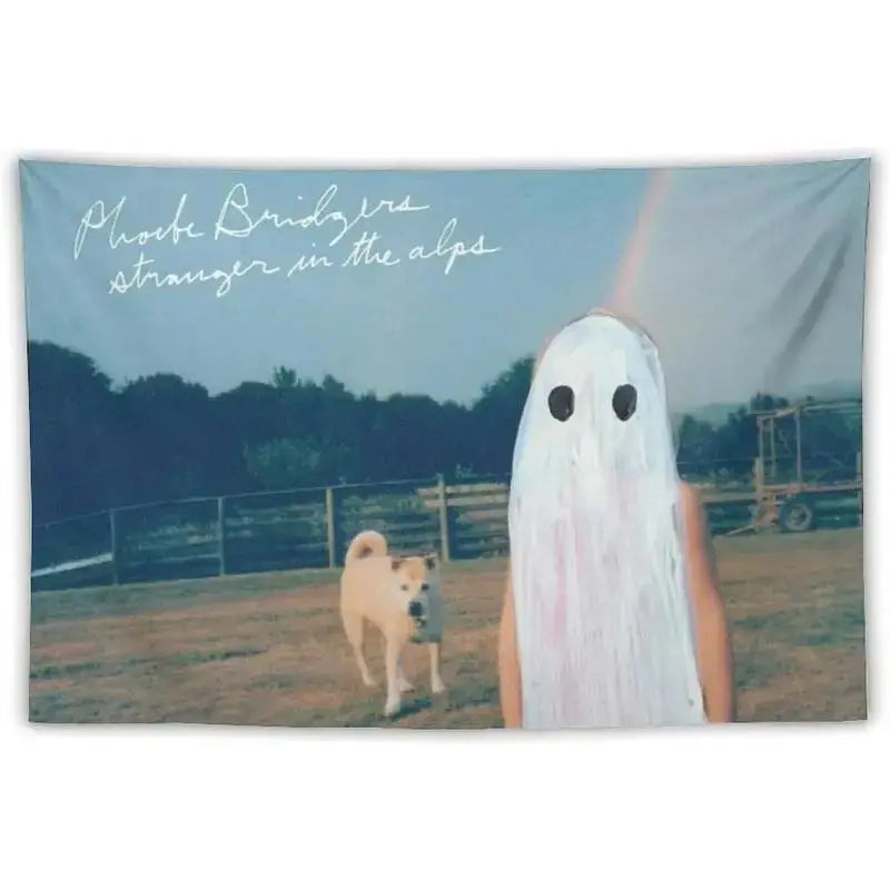 A wall tapestry featuring a ghostly white figure in the Alps landscape with text reading 'stroke bridges stranger in the alps