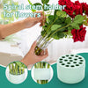 Hands hold a spiral stem holder for flowers, showing the product and its components.