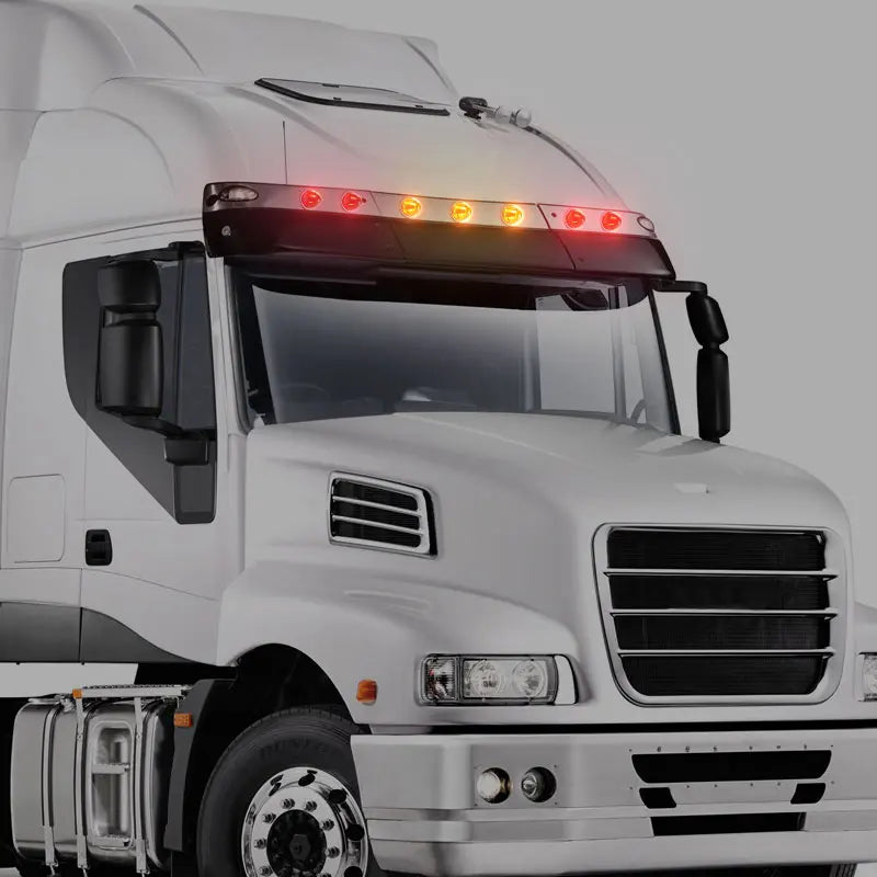 Close-up of a white truck cab showing durable LED side marker lights on the hood and grille.