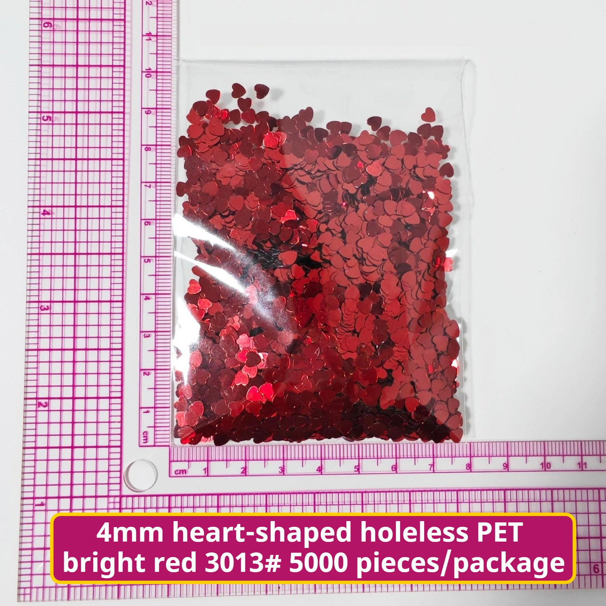 A package of 5000 pieces of bright red heart-shaped holeless PET confetti.