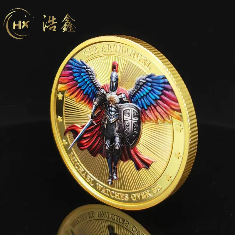 A gold medal coin featuring a depiction of the Archangel Michael with large feathered wings and a sword.