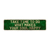 Vintage metal sign with green background and white text that reads Take time to do what makes your soul happy