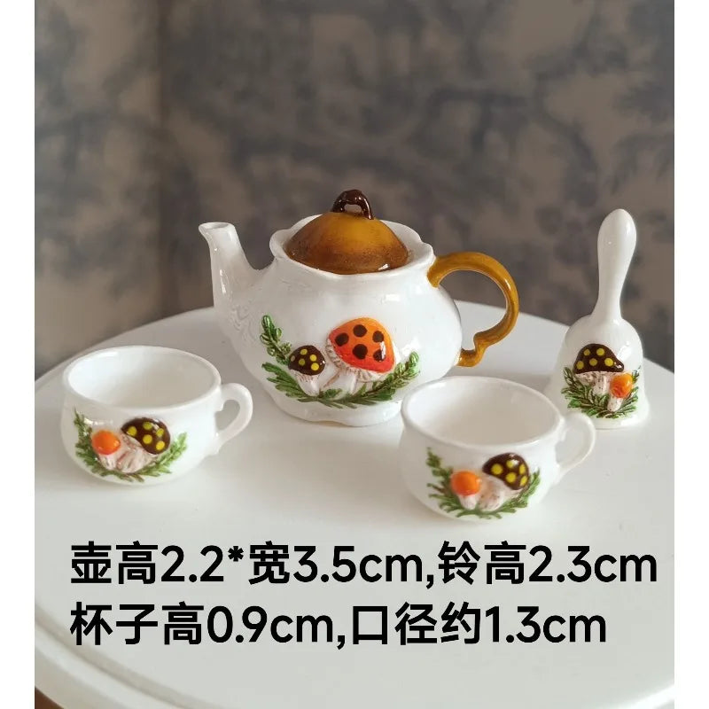 A set of handcrafted miniature white ceramic tableware featuring mushroom designs for dollhouses