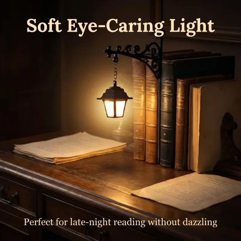 A warm lantern light illuminates a stack of old books and a piece of paper on a wooden surface.
