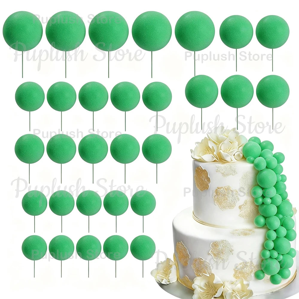 A set of green foam cake toppers, including round and leaf shapes, displayed on white cake bases.