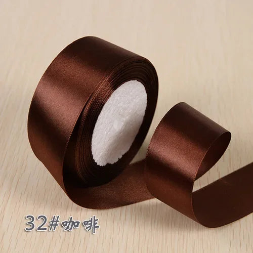 A roll of brown silk satin ribbon used for gift wrapping and craft projects.