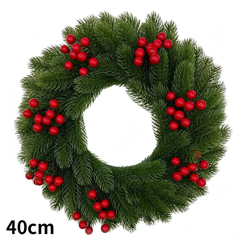 Green artificial Christmas wreath decorated with red berries and a velvet bow