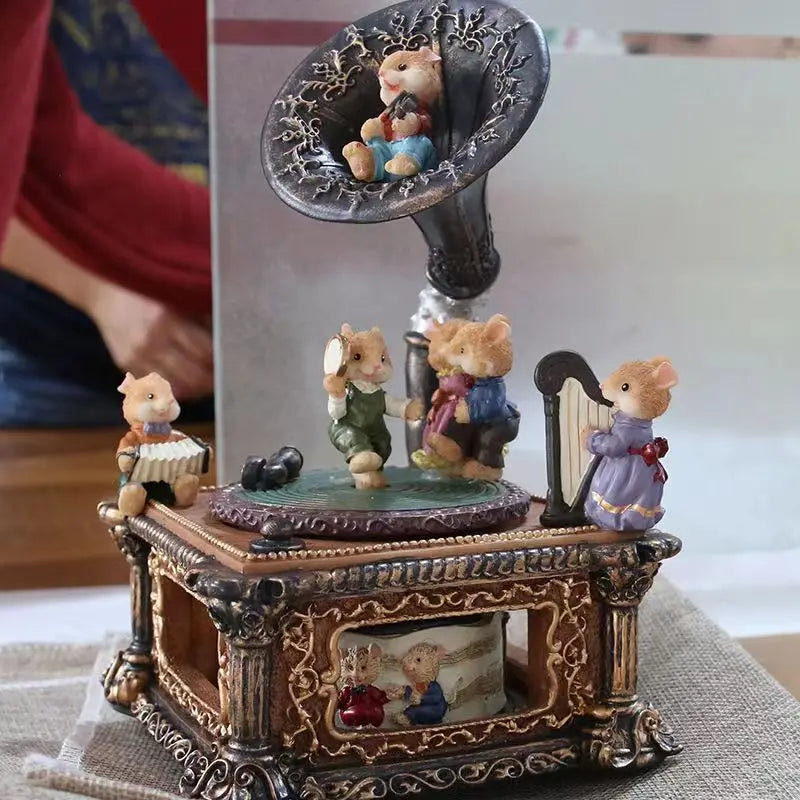 A vintage carousel music box decoration featuring small animal figures on an ornate wooden base.