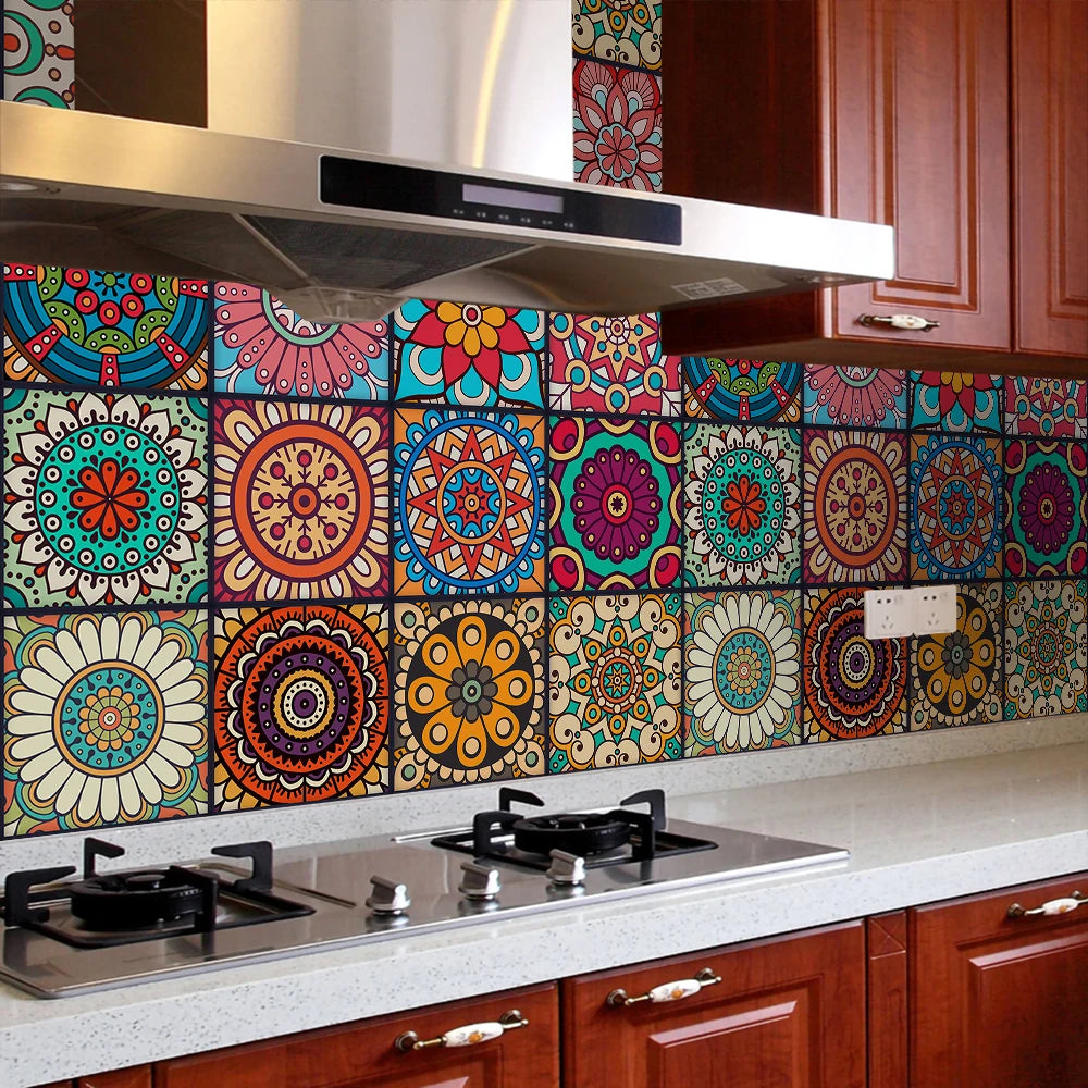 A kitchen backsplash featuring colorful mandala peel and stick tiles on a brown cabinet and stainless steel countertop.