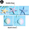 A set of five ocean animal cake toppers including starfish, turtle, octopus, whale, and shell decor.