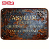 A rectangular, distressed metal sign with gold lettering that reads Asylum for the Criminally Insane Family Entrance